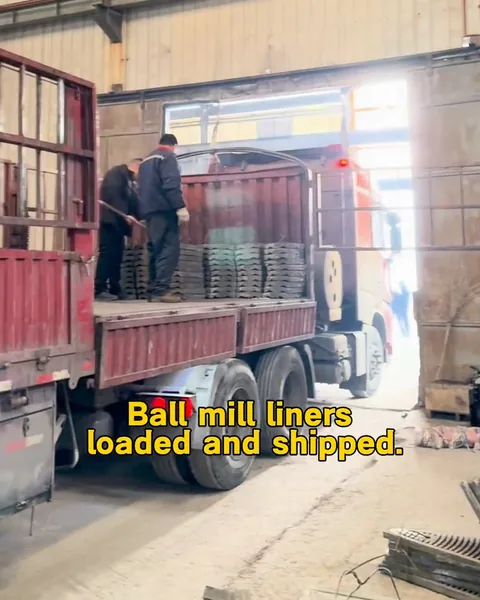 Workers beside stacked liners on a truck inside the workshop.