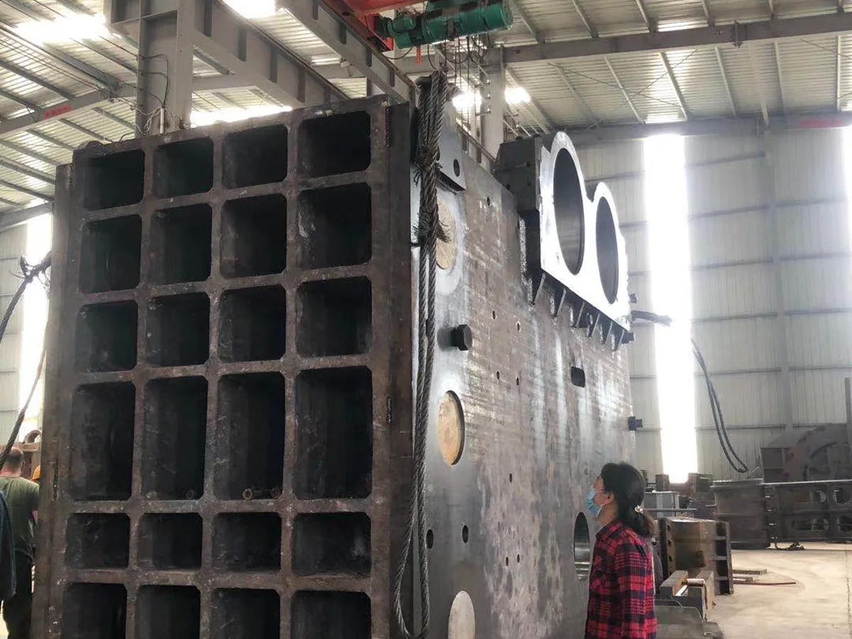Large jaw crusher frame with engineer inside Zhongji Machinery workshop